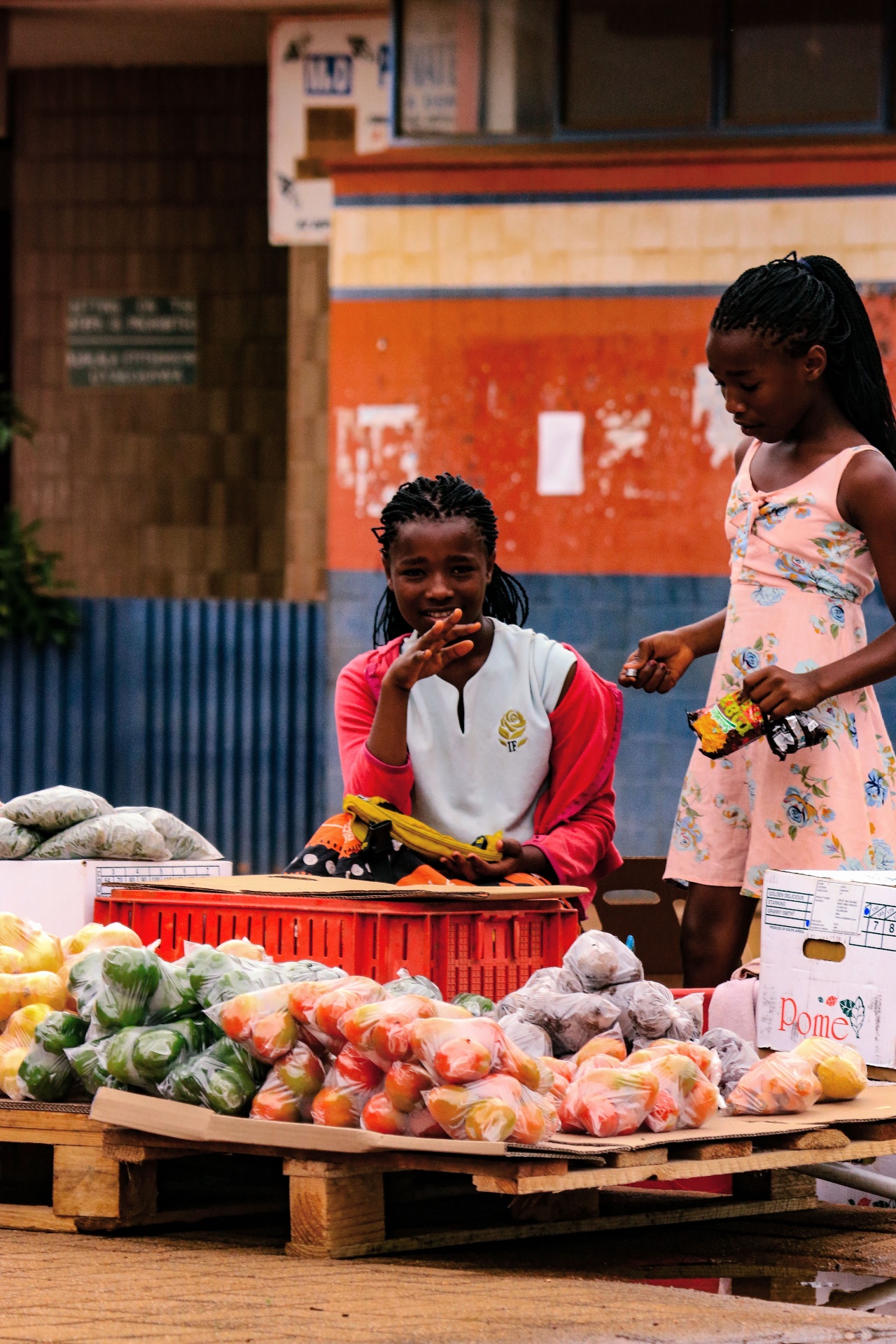 Young vendor selling fresh produce from a street stall